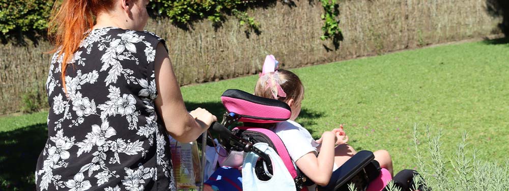 disability worker with child in wheelchair