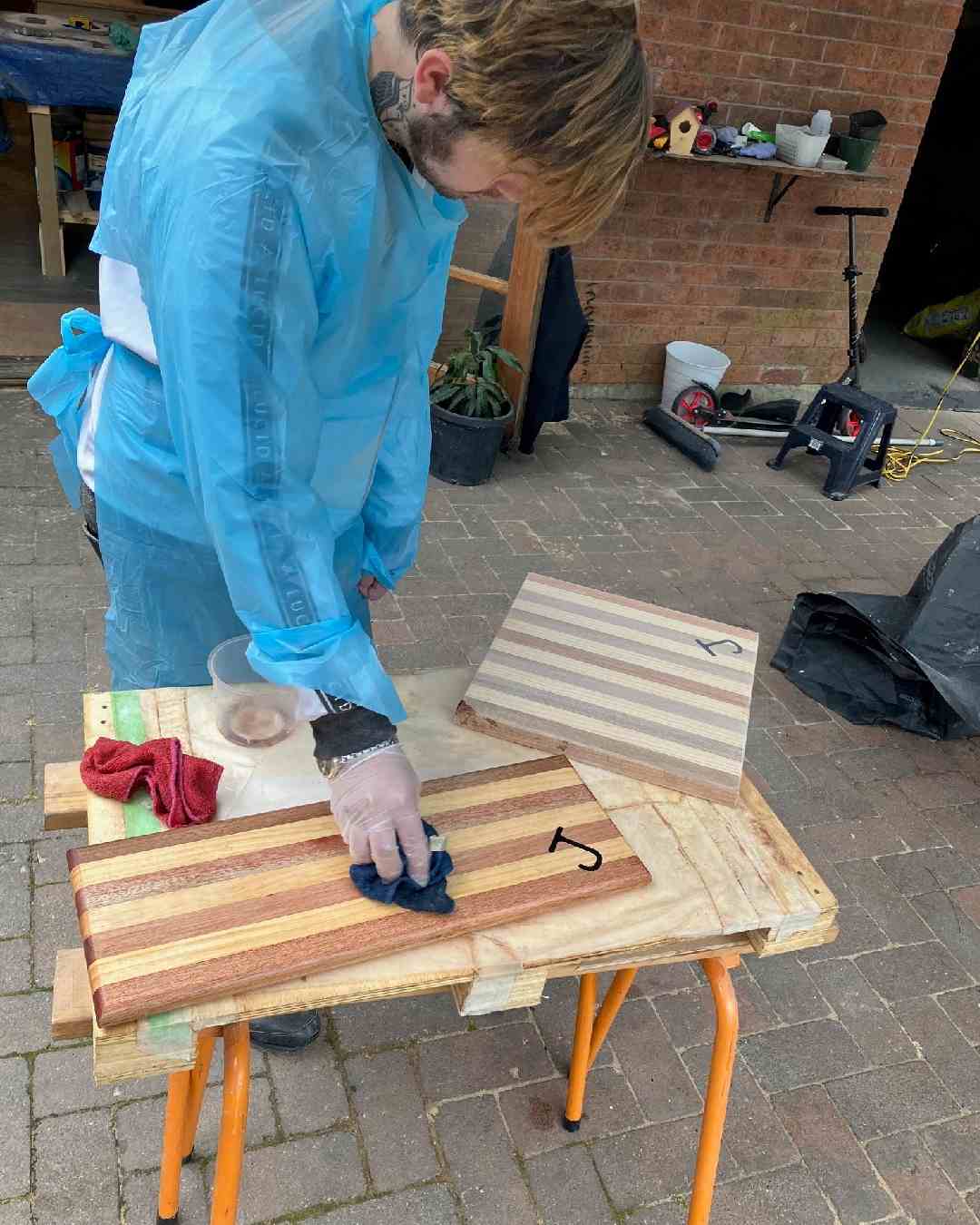 man lacquering wood